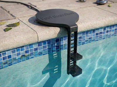 Pool Guardian sensor mount clipped to the tiled coping with both sensors hanging at the water line