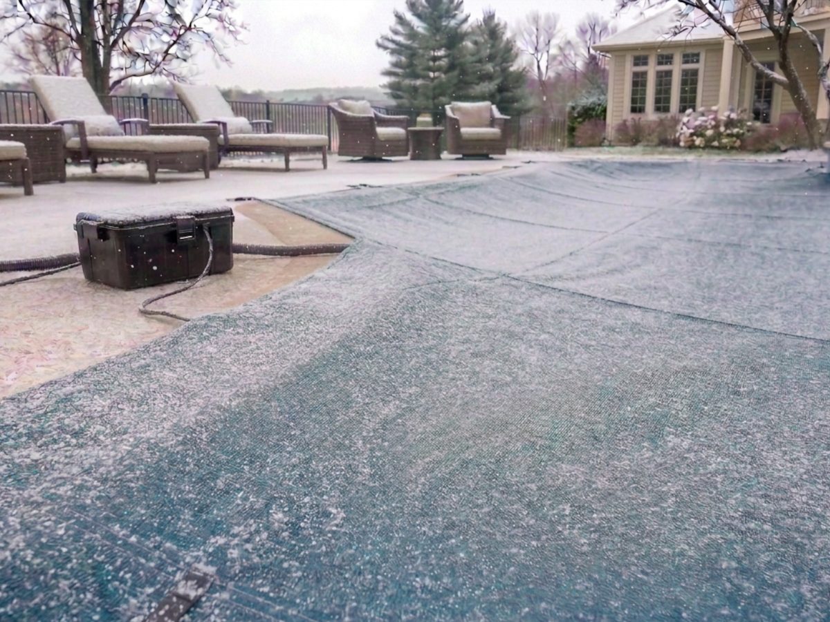 Pool Guardian controller running beside a covered pool during a winter snowfall